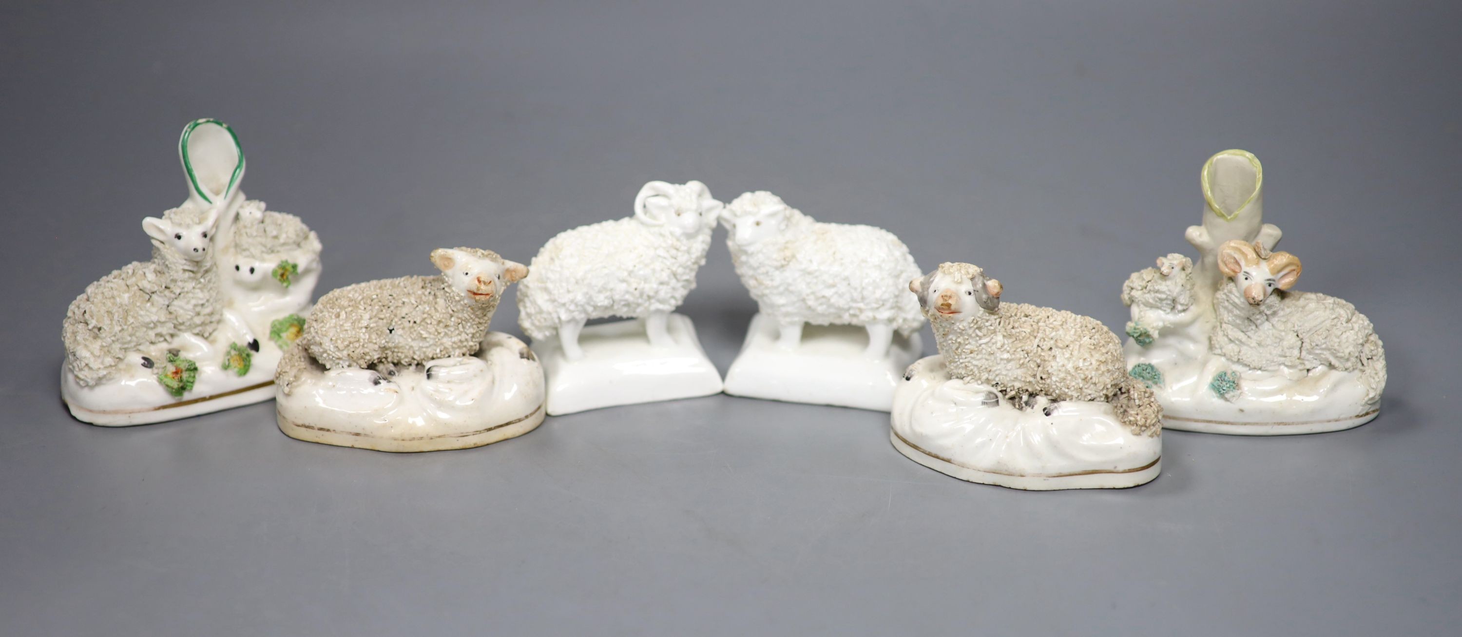 Two pairs of Staffordshire porcelain figures of sheep and two similar ‘sheep’ spill vases, c.1830-50, tallest 8.5 cm